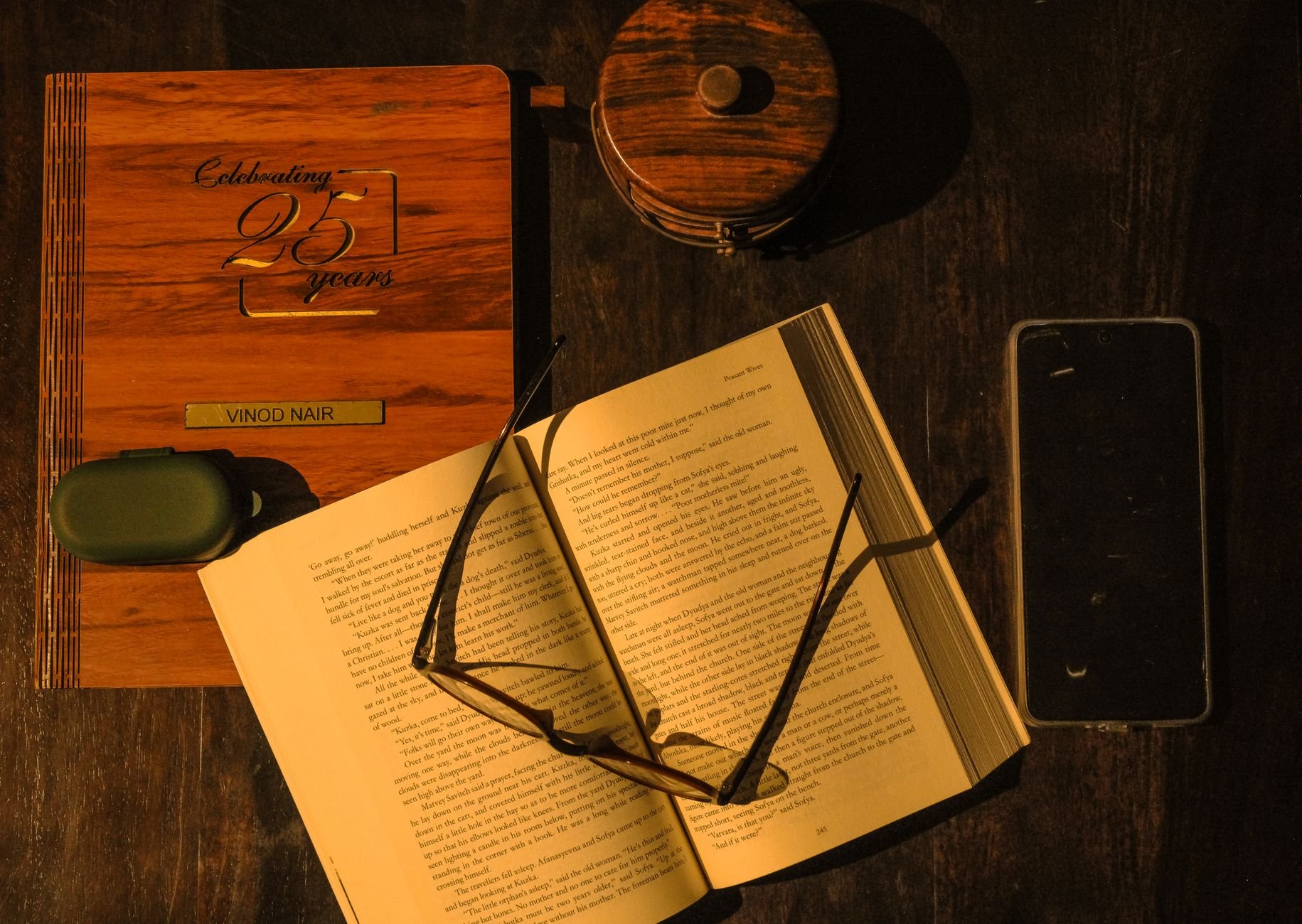 Open theological book and journal in warm ambient lighting