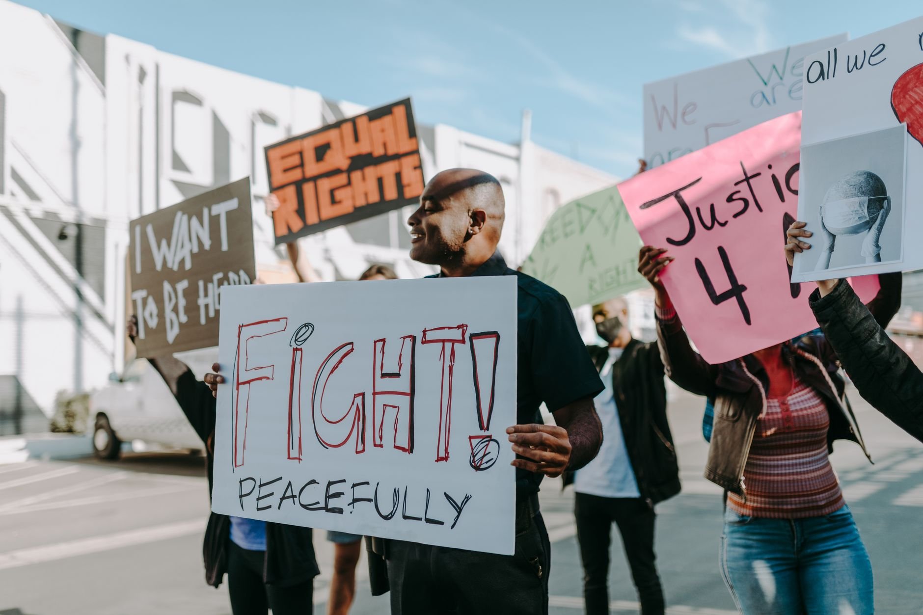 Protesters advocating for equal rights and justice with peaceful protest signs